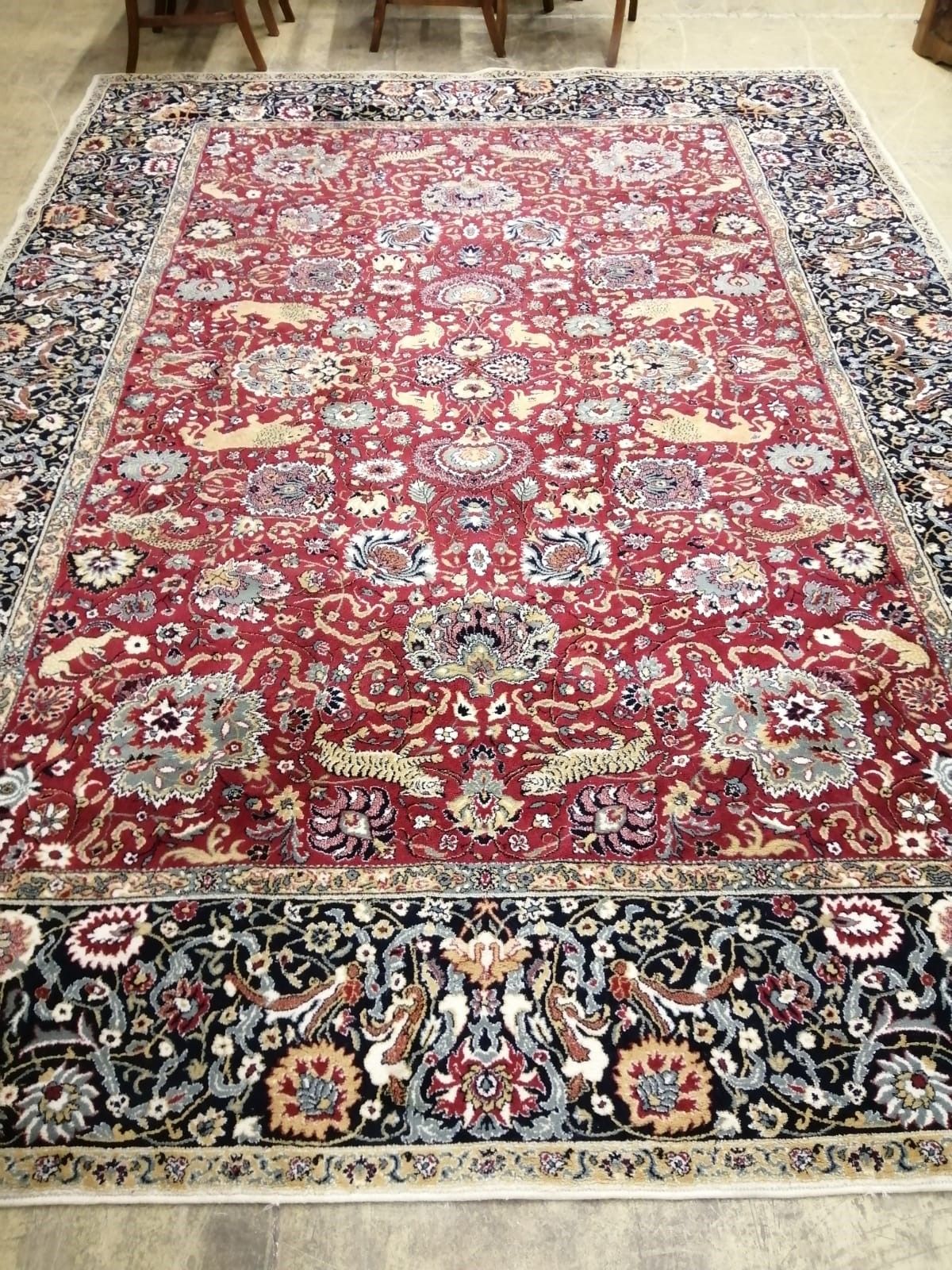 A Kashan burgundy ground carpet, 344 x 250cm